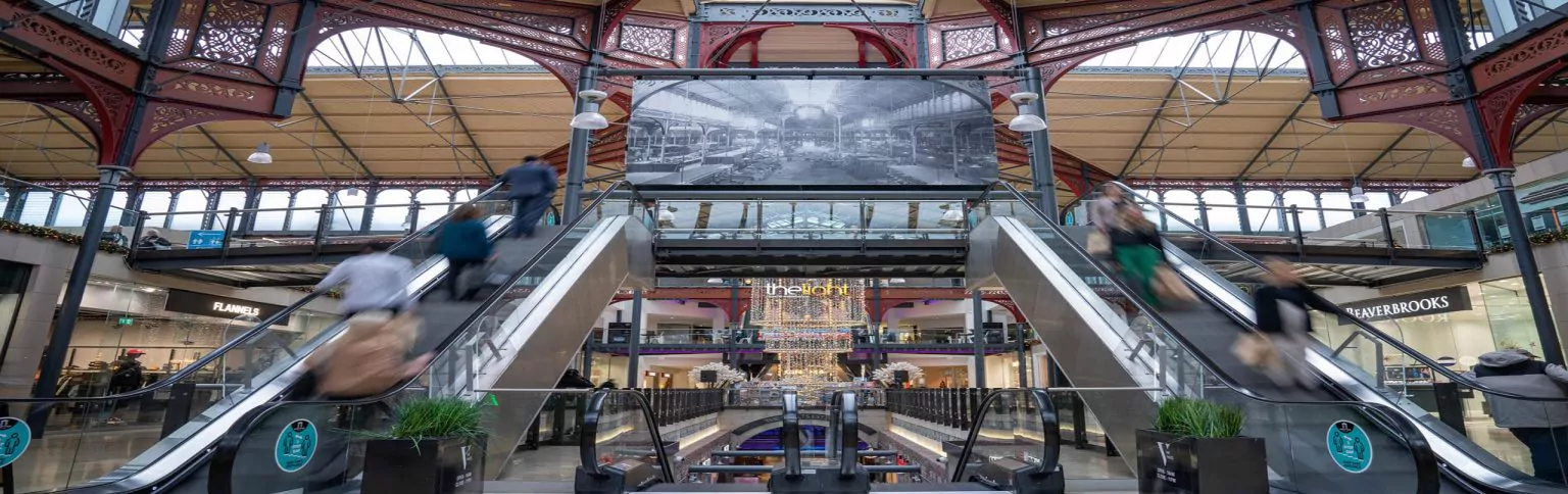 Entrance of Marketplace Shopping Centre with people on escalators